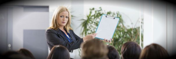 A corporate trainer leading a business training seminar. 