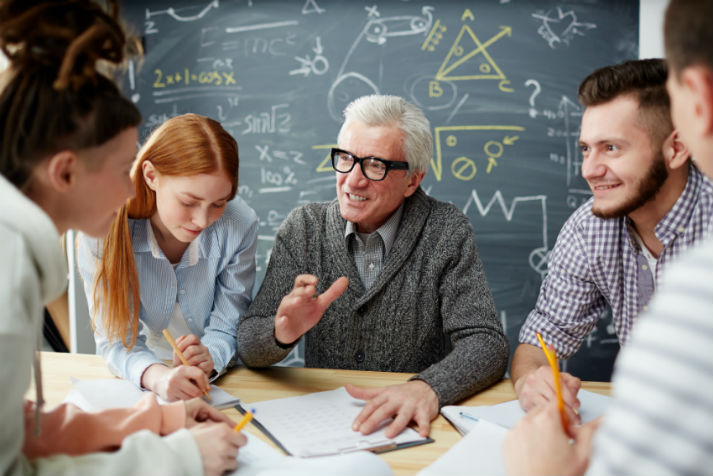 Professor helping small group of students